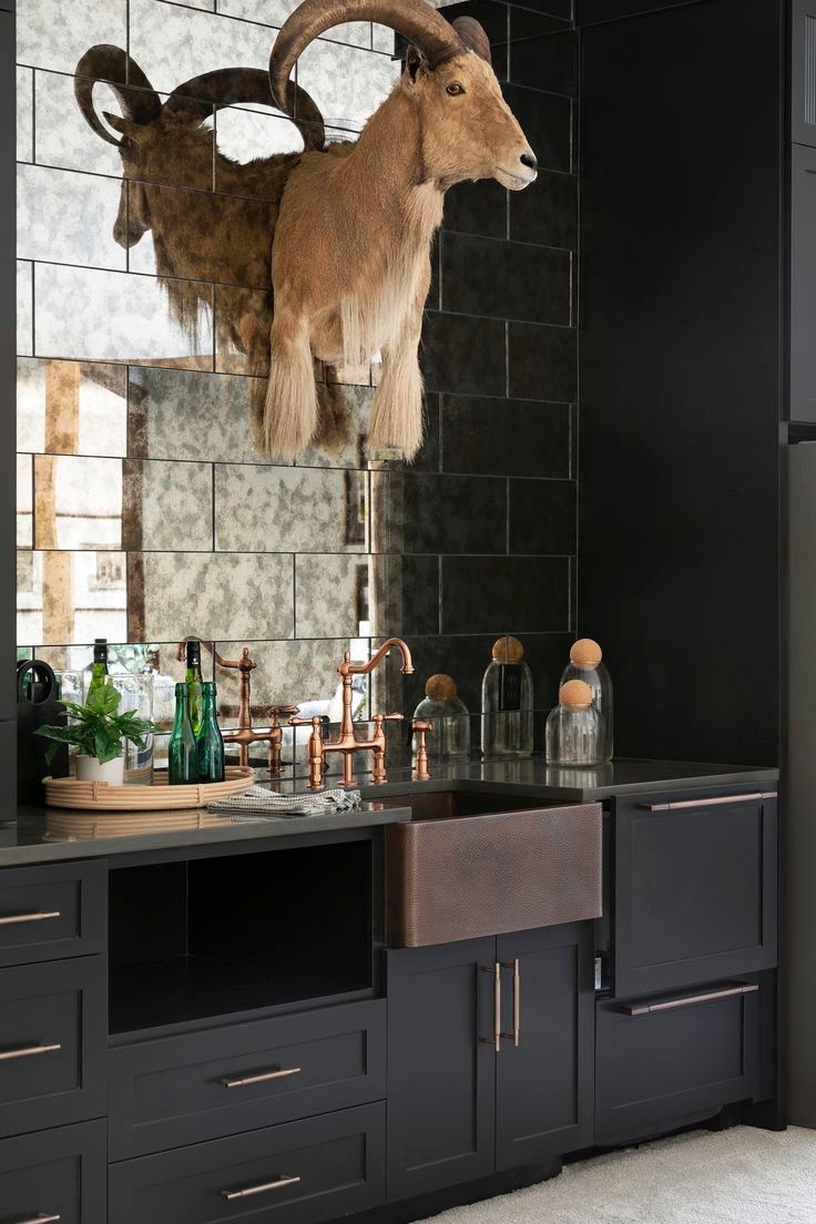 Basement bar with antique mirror tile backsplash and black cabinets