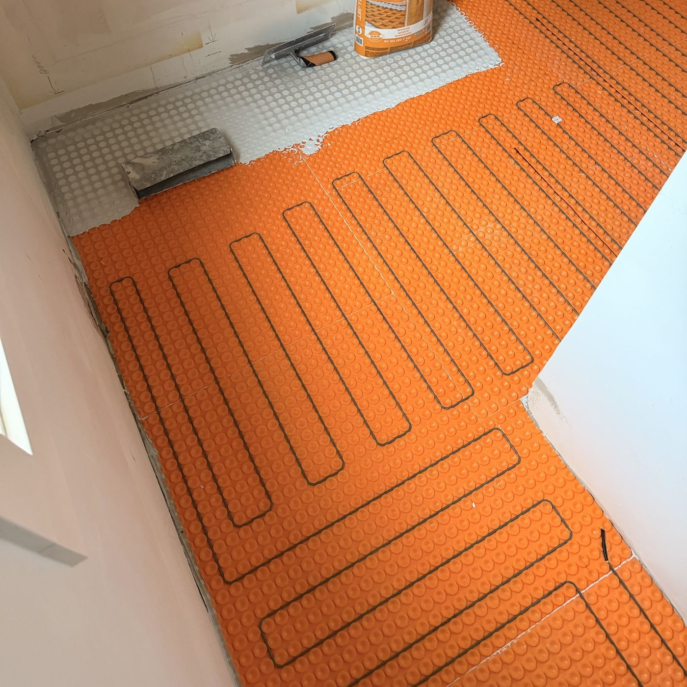 Heating cables laid in a bathroom floor membrane