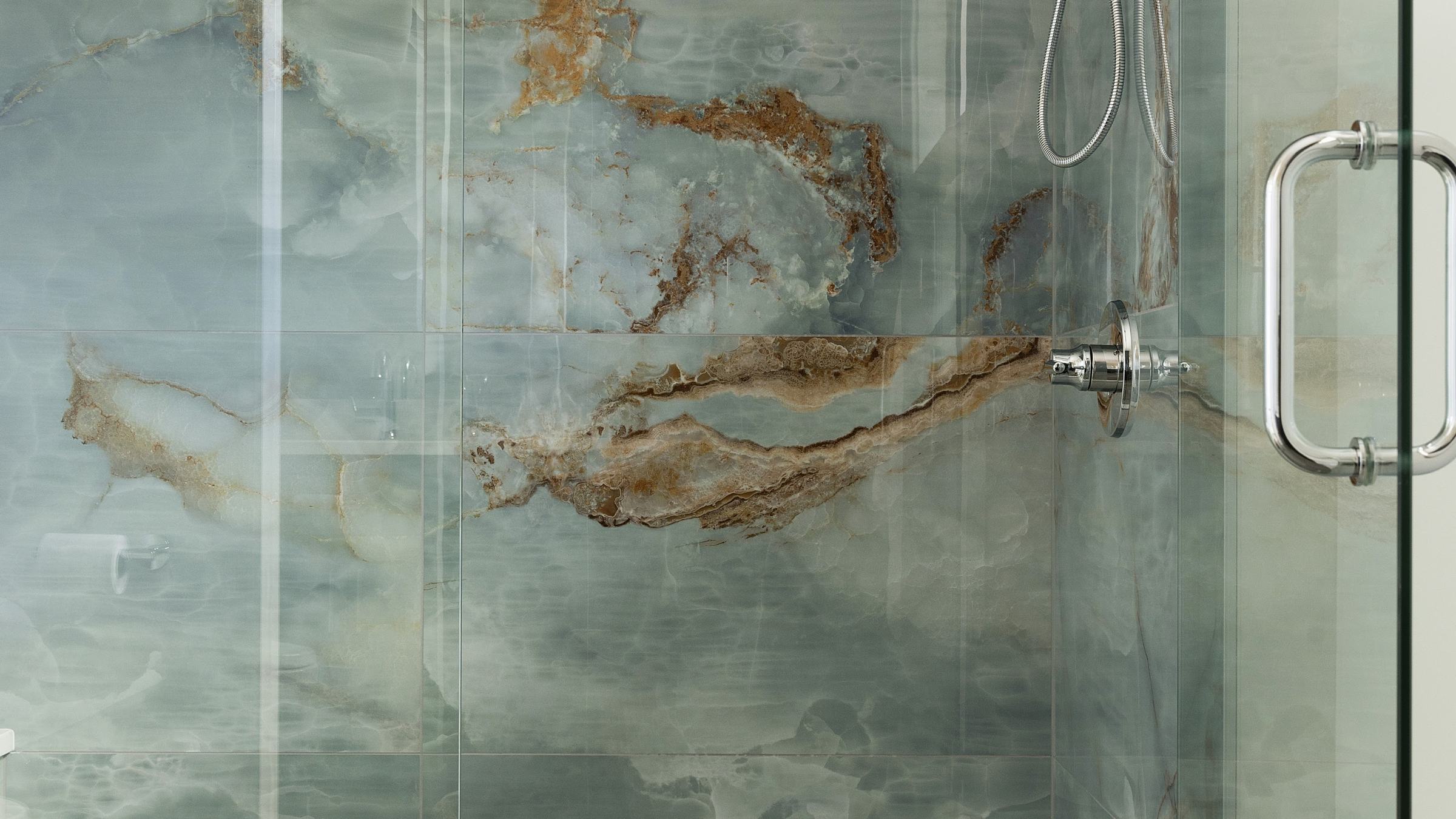 Shower with large blue onyx-look slab walls