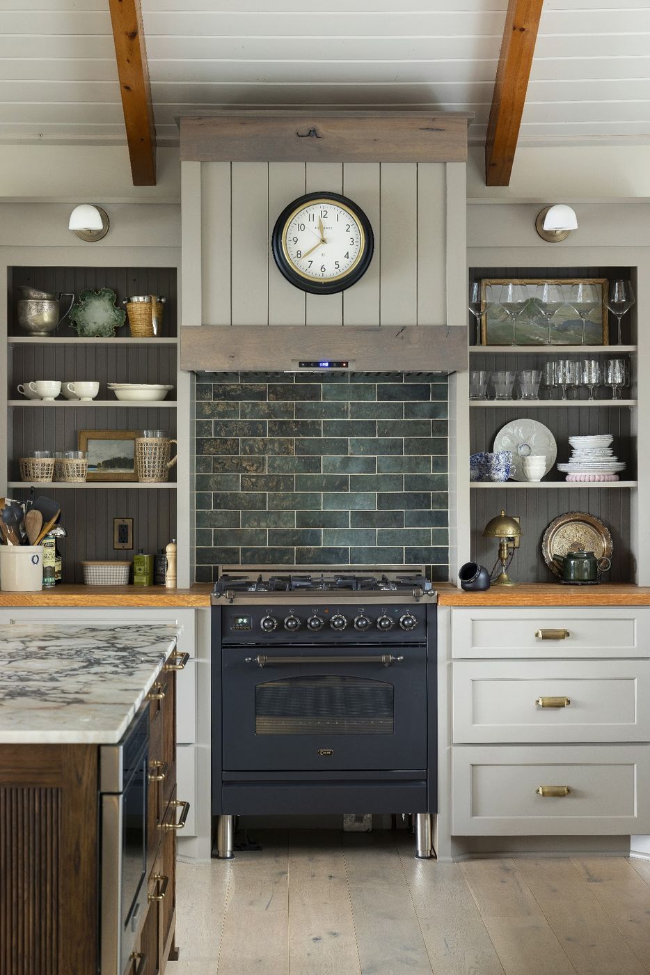 Farmhouse kitchen with a green glazed tile backsplash behind the range