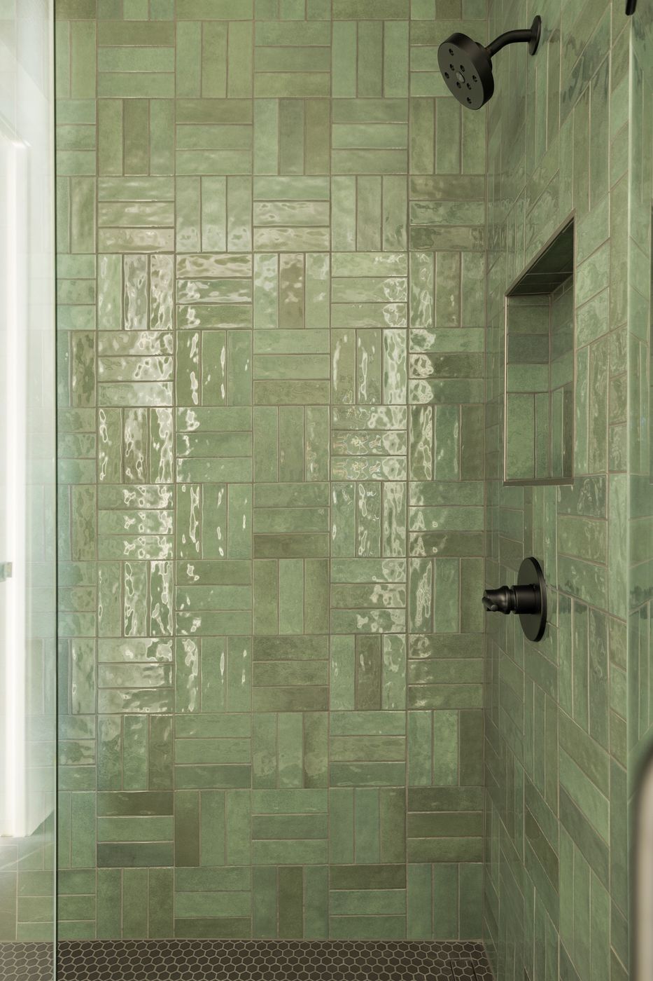 Shower with glossy green tile in a mixed vertical and horizontal pattern